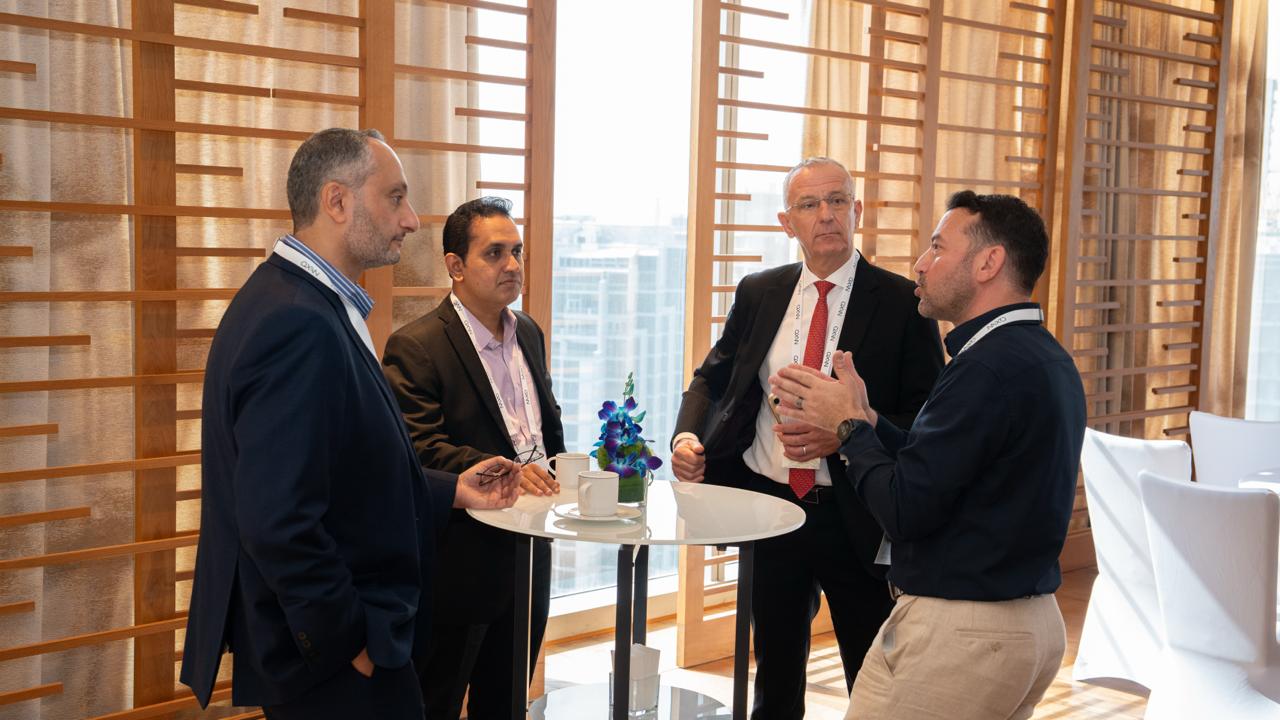 AXON team members and guests in conversation during the Dubai reception