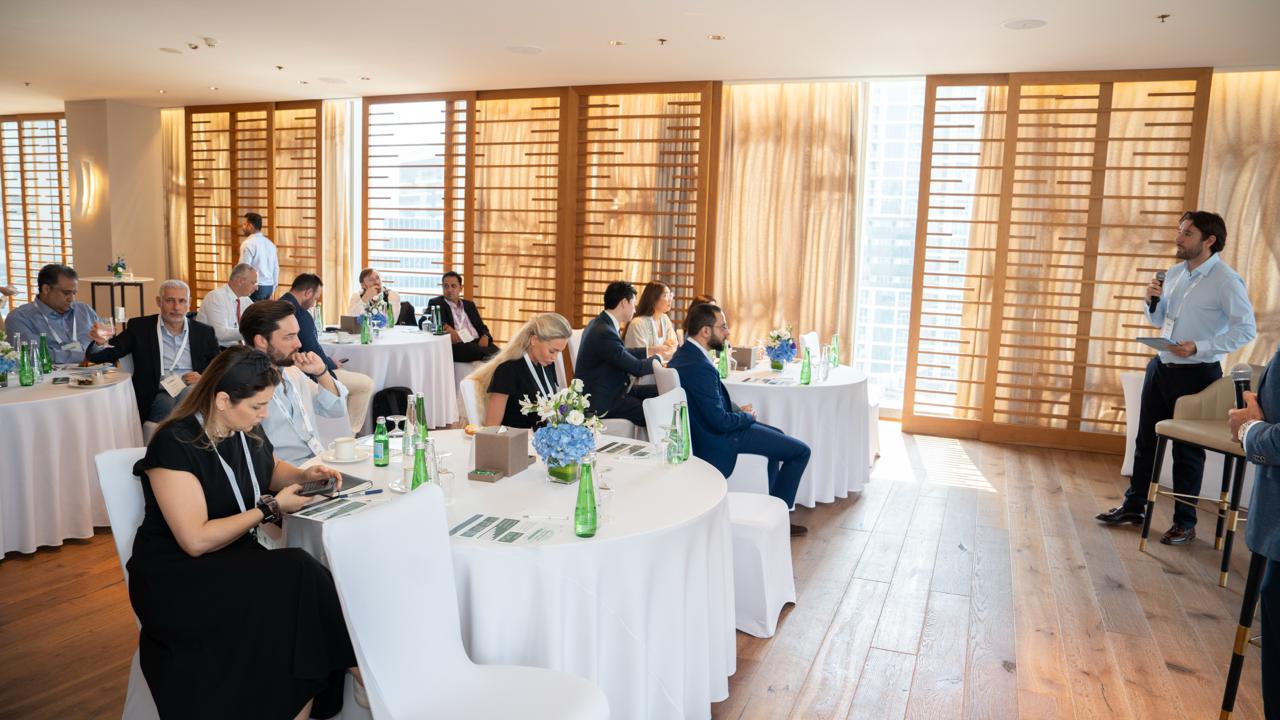 Investors seated at round tables during the AXON Dubai reception