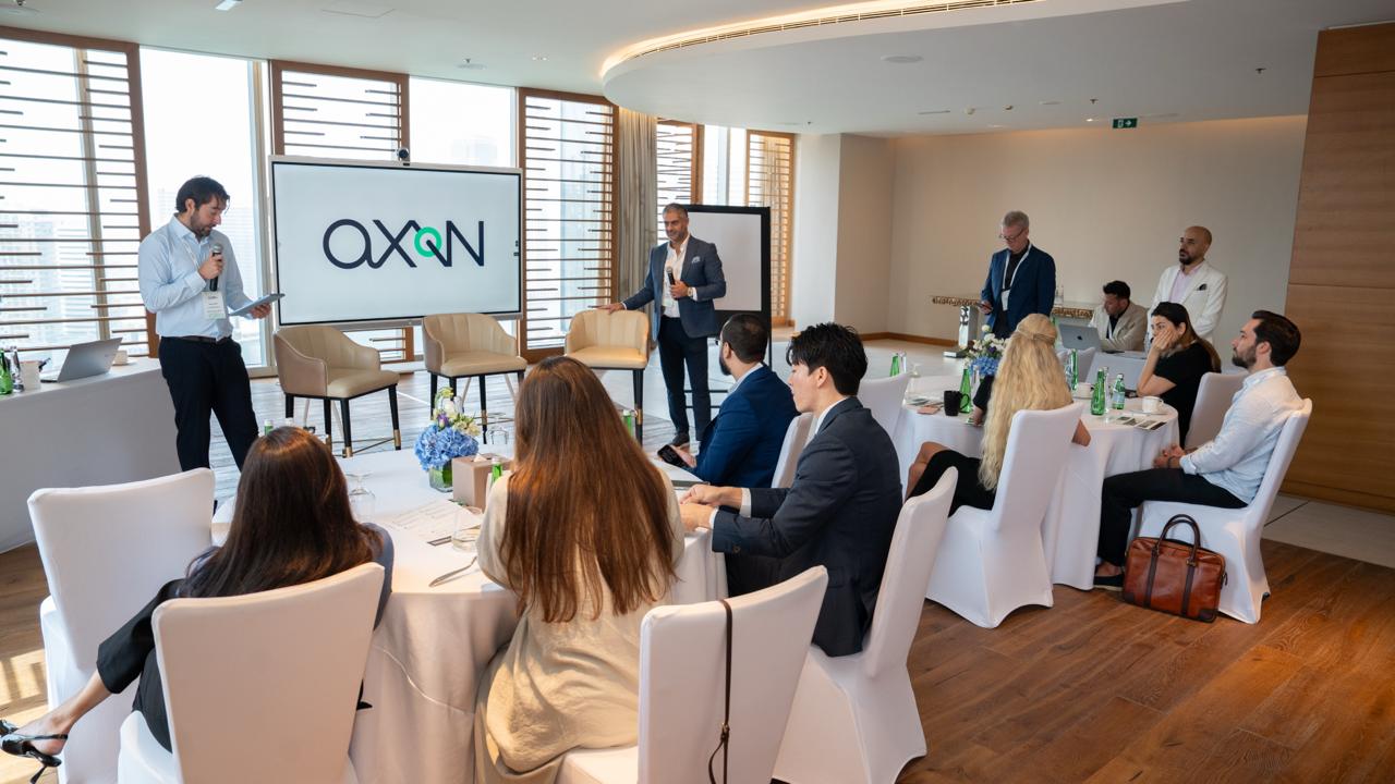 Oliver Kirkbright and Tamer Saudi presenting 'In Conversation: Why Now?' at the AXON Dubai reception